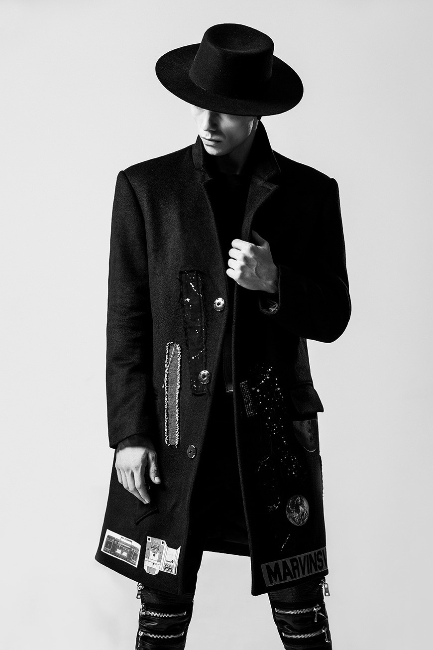 Man standing in a classic front-facing pose, showcasing his stylish outfit with confidence
