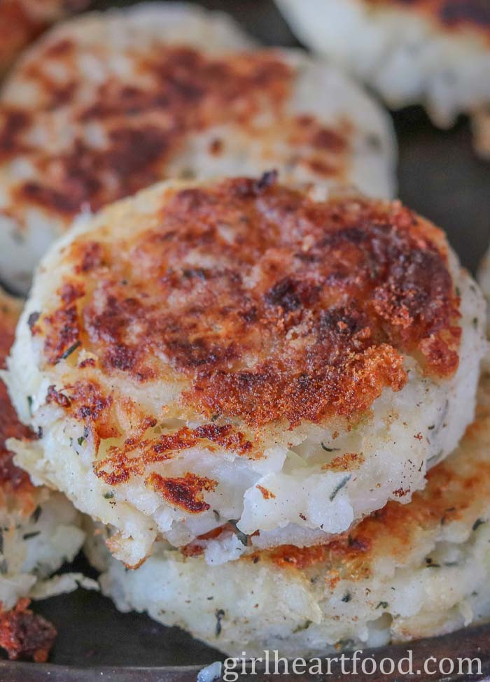 Close-up of cooked traditional Newfoundland salt cod fish cakes on a sheet pan.