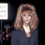Sade in a suit and gold hoops