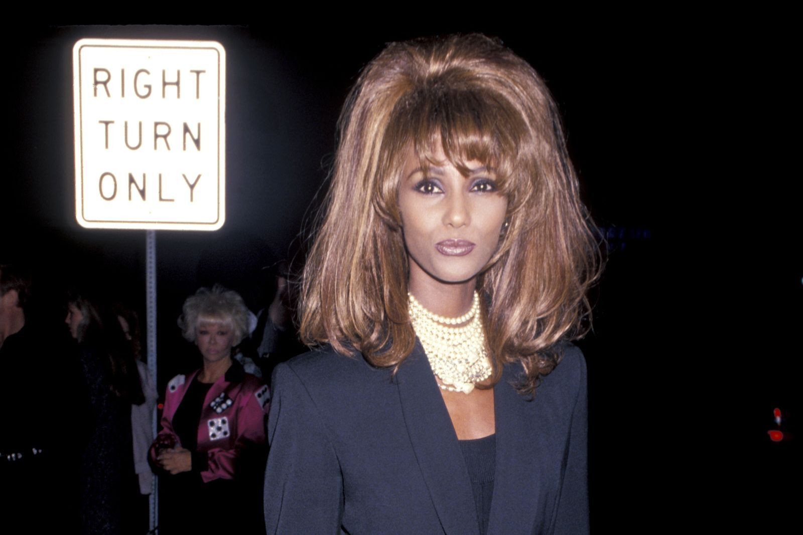 Sade in a suit and gold hoops