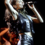 Shania Twain's signature leopard print turtleneck and leather ensemble.