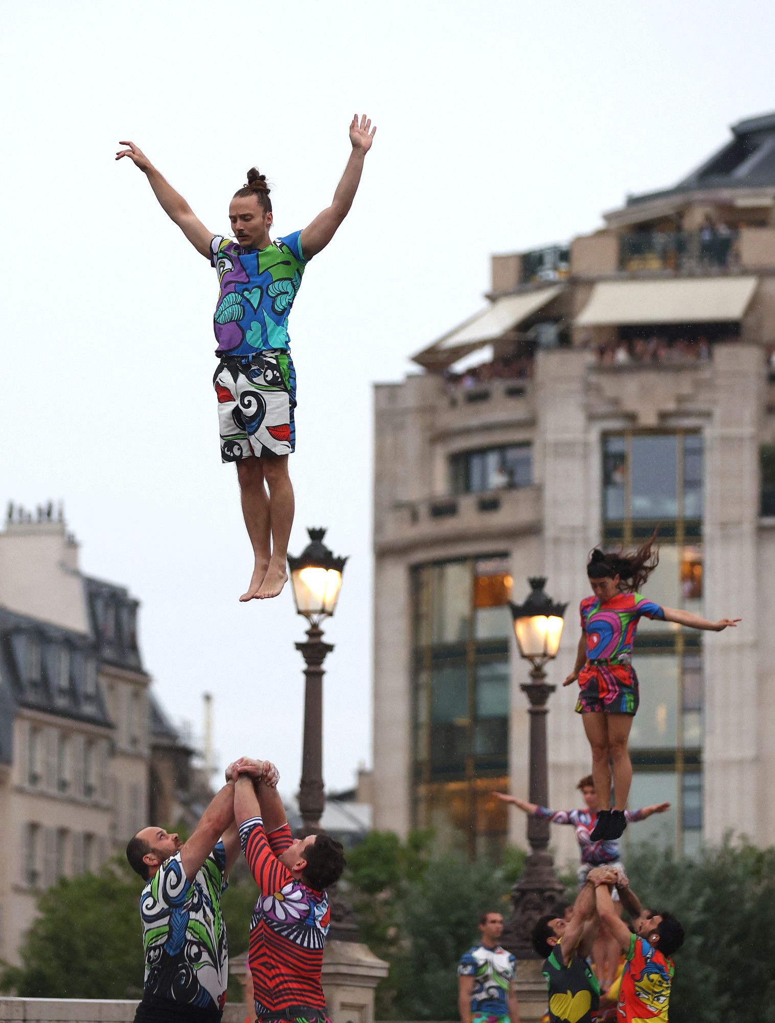 Dancers on poles wearing Charles De Vilmorin at the opening ceremony of the Paris 2024 Olympic Games