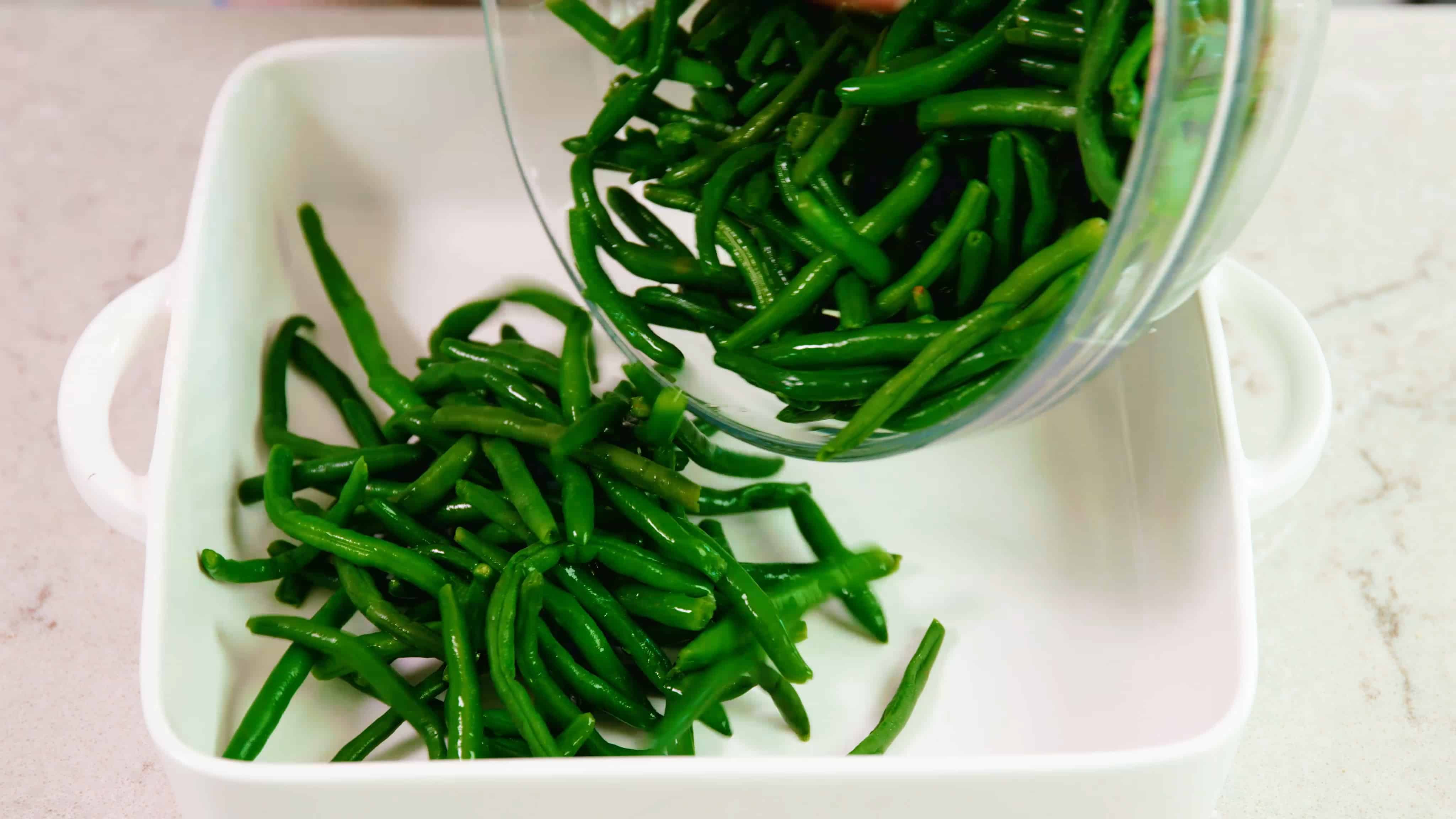 Fresh green beans being prepared for cooking.