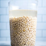 Navy beans soaking in large pitcher for grandma's ham and bean soup