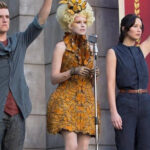 Effie Trinket in The Hunger Games: Catching Fire, wearing a dress made of hand-painted monarch butterflies