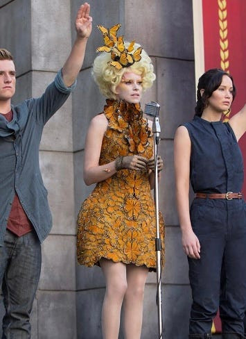Effie Trinket in The Hunger Games: Catching Fire, wearing a dress made of hand-painted monarch butterflies