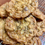 Stack of chocolate chip oatmeal cookies on a wire rack.