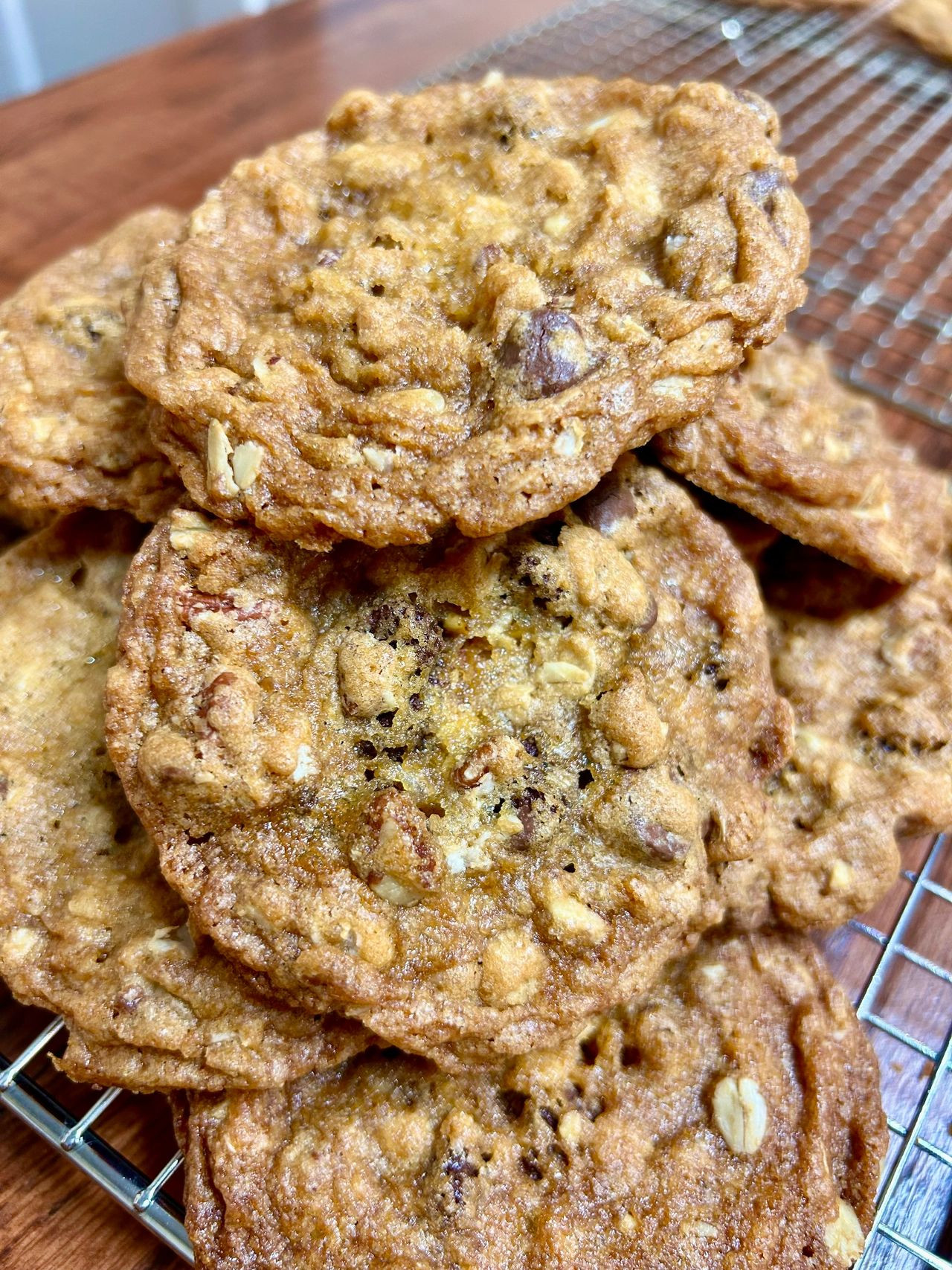 Stack of chocolate chip oatmeal cookies on a wire rack.