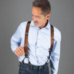 Man wearing brown suspenders over a white dress shirt