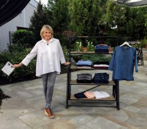 Martha Stewart showcasing her new fashion line of shirts, blouses, pants and jackets, all priced under $65, emphasizing high quality and affordability.