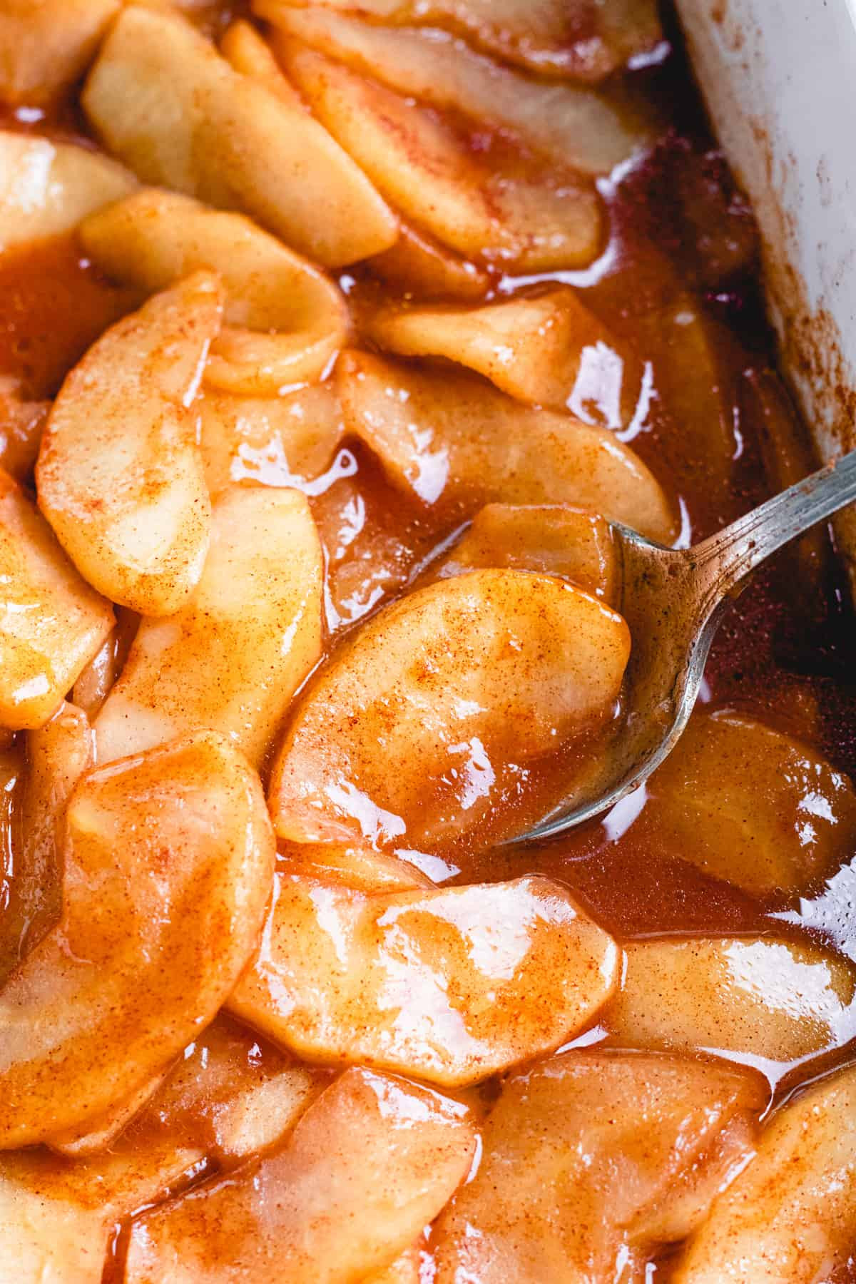 Baked apple slices showcasing a golden-brown, caramelized surface, appealing to culinary enthusiasts with their rustic charm.