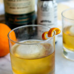 Close-up of a Jameson Orange Old Fashioned, highlighting the orange twist garnish
