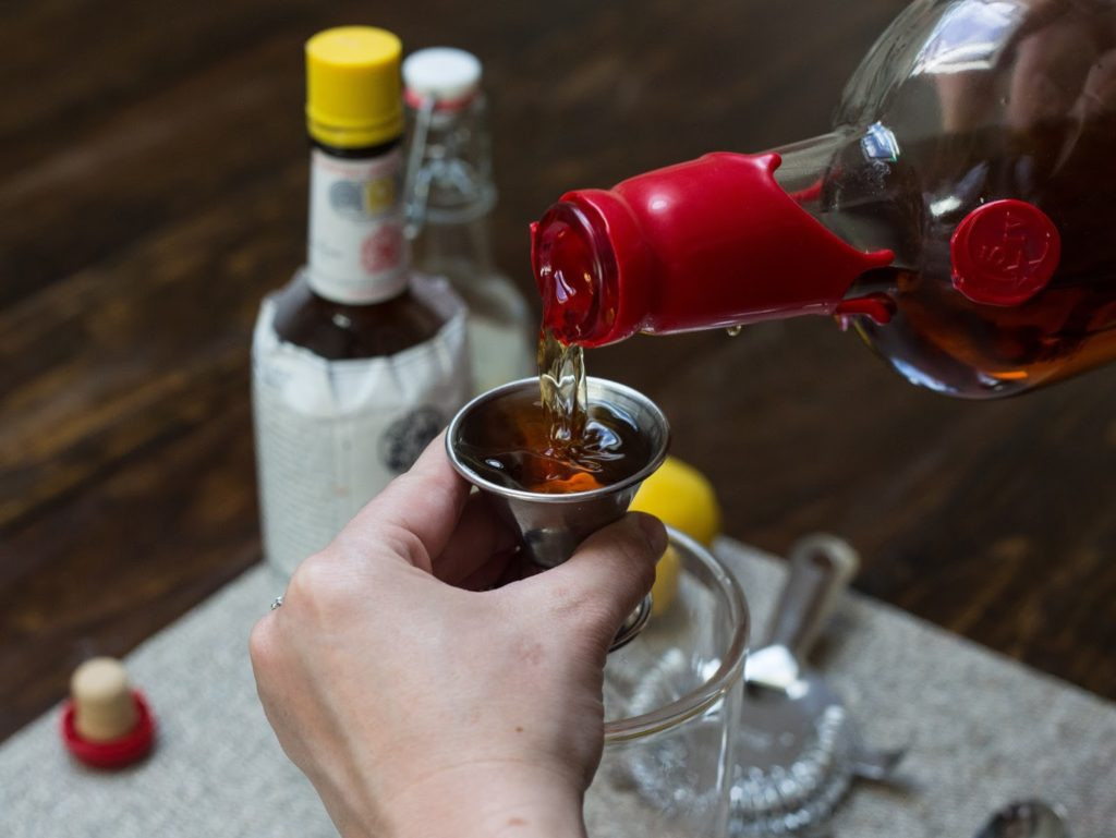Close-up of an old fashioned cocktail with a thick orange peel