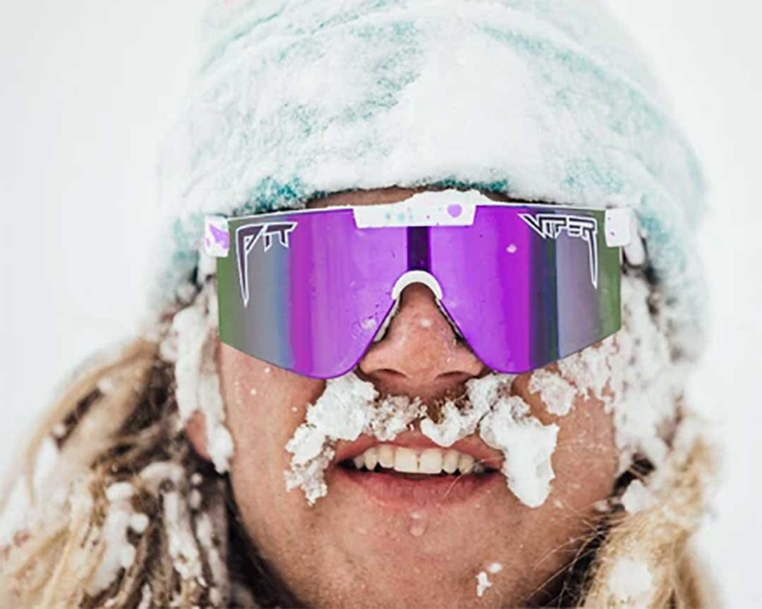 Man with snow in his hair and moustache wearing purple tinted 80