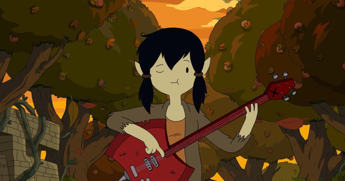 Man in a yellow jacket and black jeans with an electric guitar