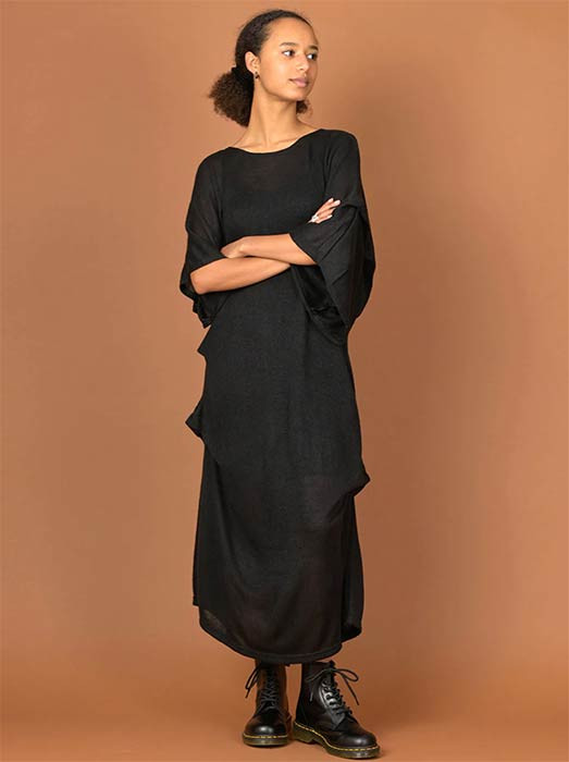 A person wearing a black maxi dress