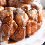 Close-up shot of monkey bread being pulled apart, showcasing the soft dough and caramelized sugar.