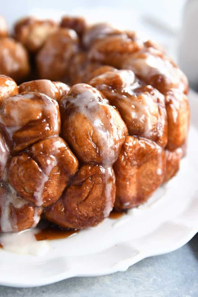 Close-up shot of monkey bread being pulled apart, showcasing the soft dough and caramelized sugar.