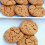 Old-fashioned ginger cookies arranged on a wooden board.
