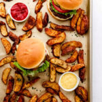 Classic hamburger on a sesame seed bun with lettuce, tomato, and onion