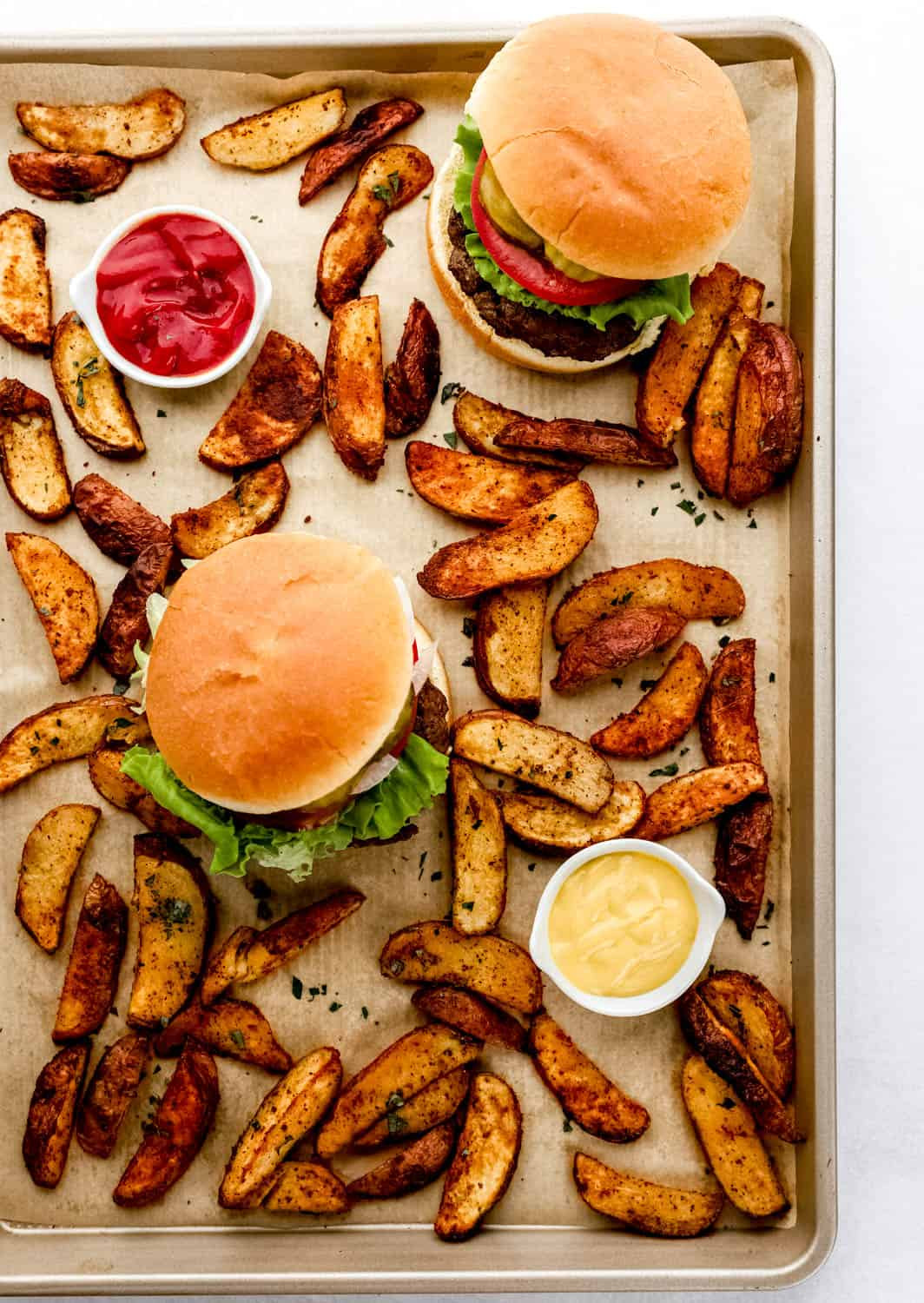 Classic hamburger on a sesame seed bun with lettuce, tomato, and onion