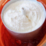Close up of ice cream churning inside an old fashioned ice cream maker