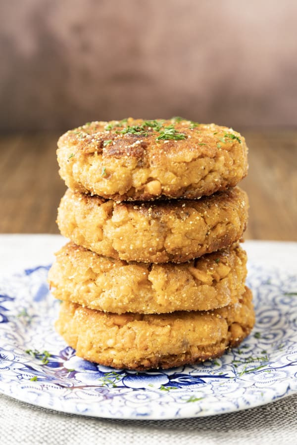 Baked salmon patties with lemon slices, showcasing a healthier cooking option