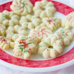 Spritz Cookies in a white plate with red design on a white background