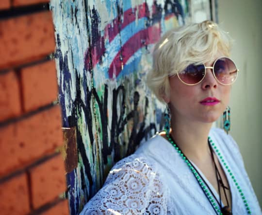 Man wearing a white bohemian dress from the 1970s