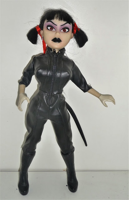 Kitty wearing a fake leather catsuit with a tail
