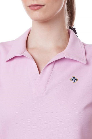 Man in a pink pastel polo shirt, bone-colored slacks and a navy blue cardigan
