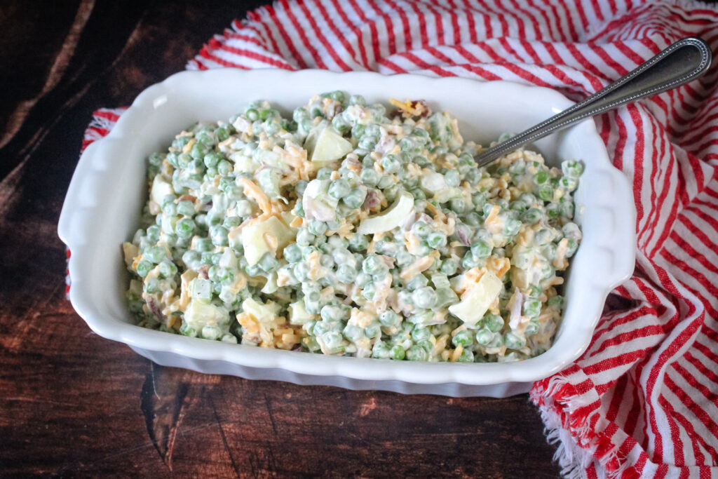Peas salad prepared in a white serving bowl