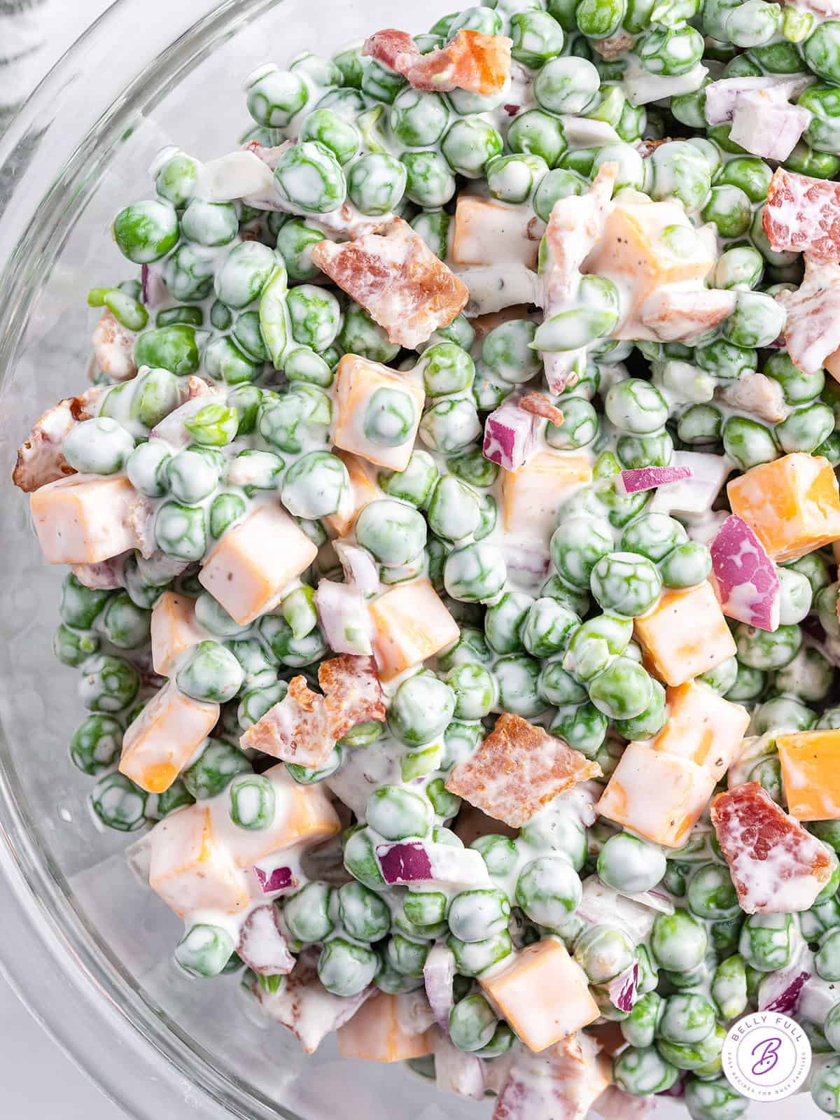 overhead close up pea salad in glass bowl