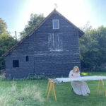 Antique quilting frame setup in a barn