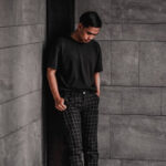 Gray plaid pants paired with a white t-shirt and white sneakers for a fresh, contemporary outfit