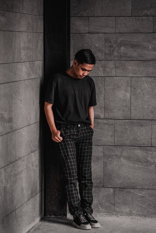 Gray plaid pants paired with a white t-shirt and white sneakers for a fresh, contemporary outfit
