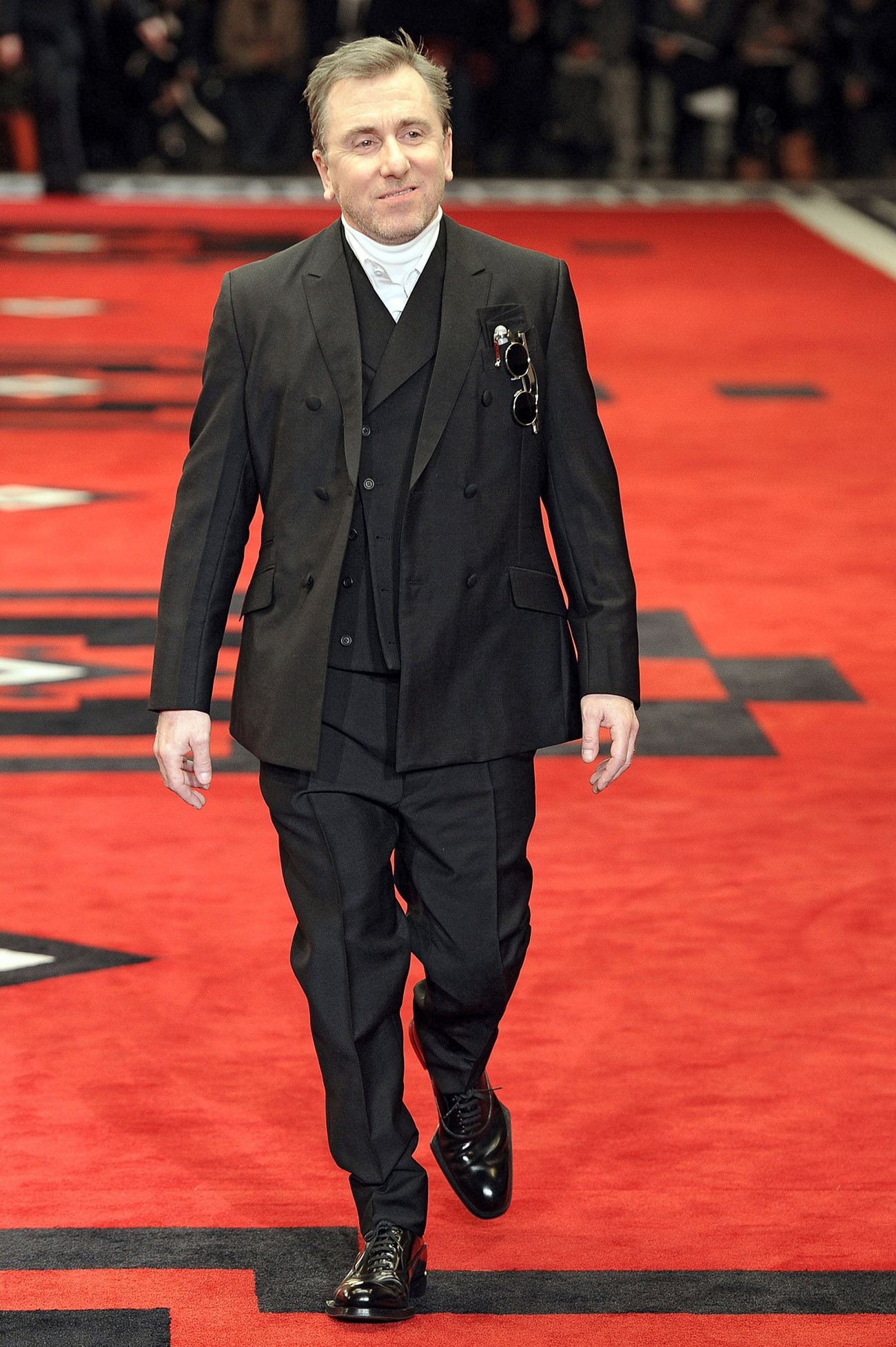 Tim Roth, the star of "Reservoir Dogs" and "Pulp Fiction," showcases Prada's collection on the runway at the Autumn/Winter 2012 fashion show during Milan Menswear Fashion Week.