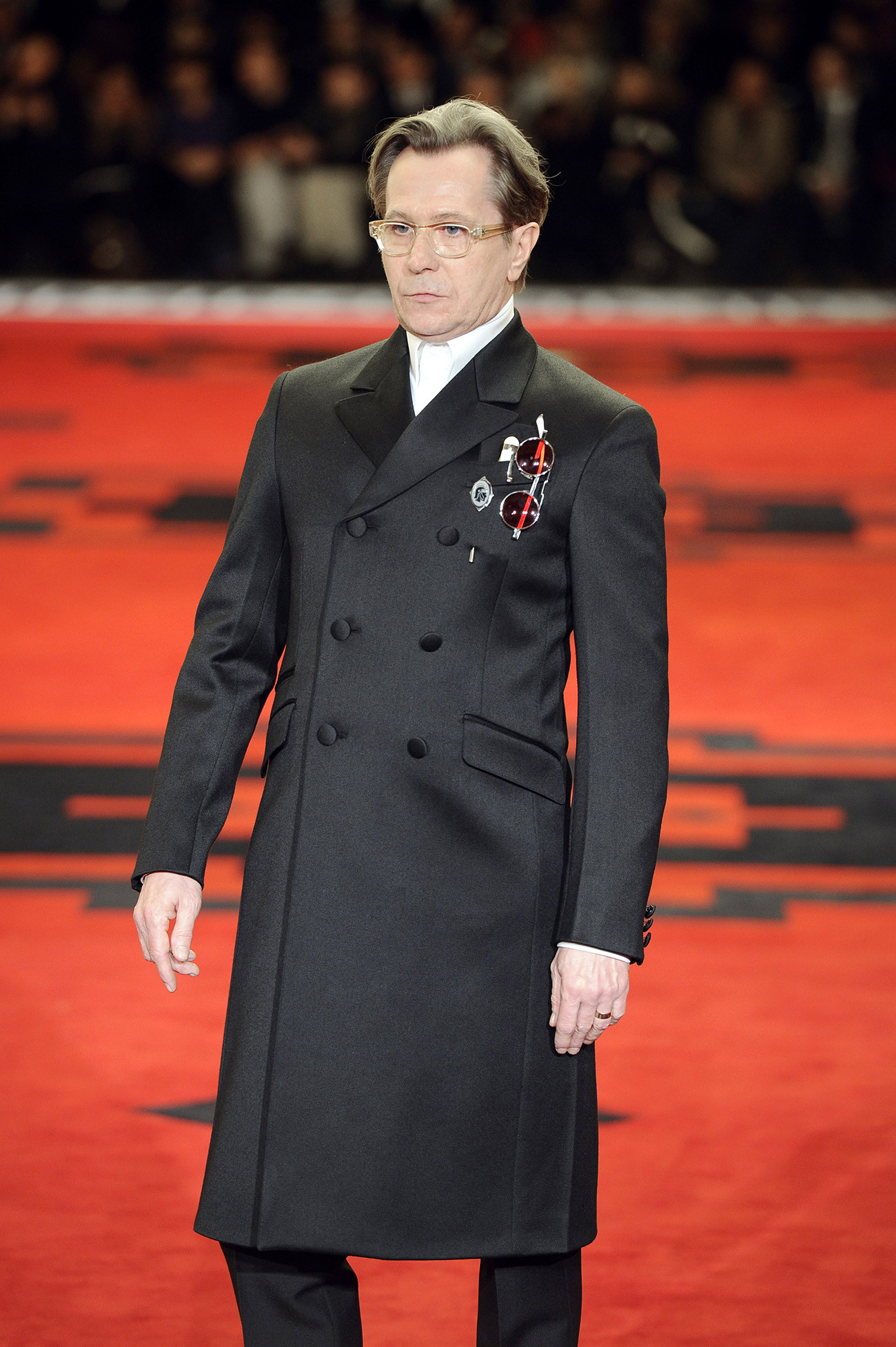 Gary Oldman embodying villainous charm on the Prada runway at the Autumn/Winter 2012 fashion show during Milan Menswear Fashion Week.