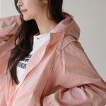 A man in a stylish Korean streetwear outfit with a graphic tee and bomber jacket.