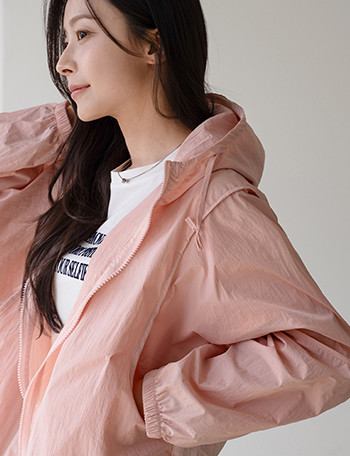 A man in a stylish Korean streetwear outfit with a graphic tee and bomber jacket.