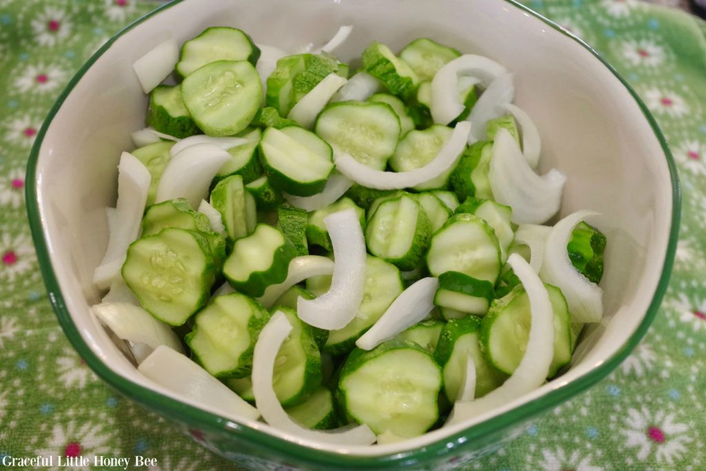Sliced cucumbers and onions in a bowl