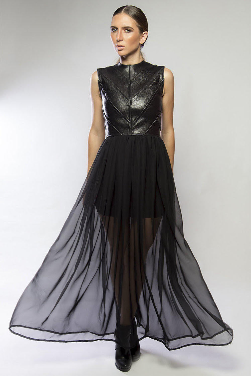 A model wearing a design from Rufus Dixon's RHDIV collection, showcasing the use of leather and bold colors.