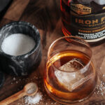 bourbon in a cocktail glass with maple syrup and salt