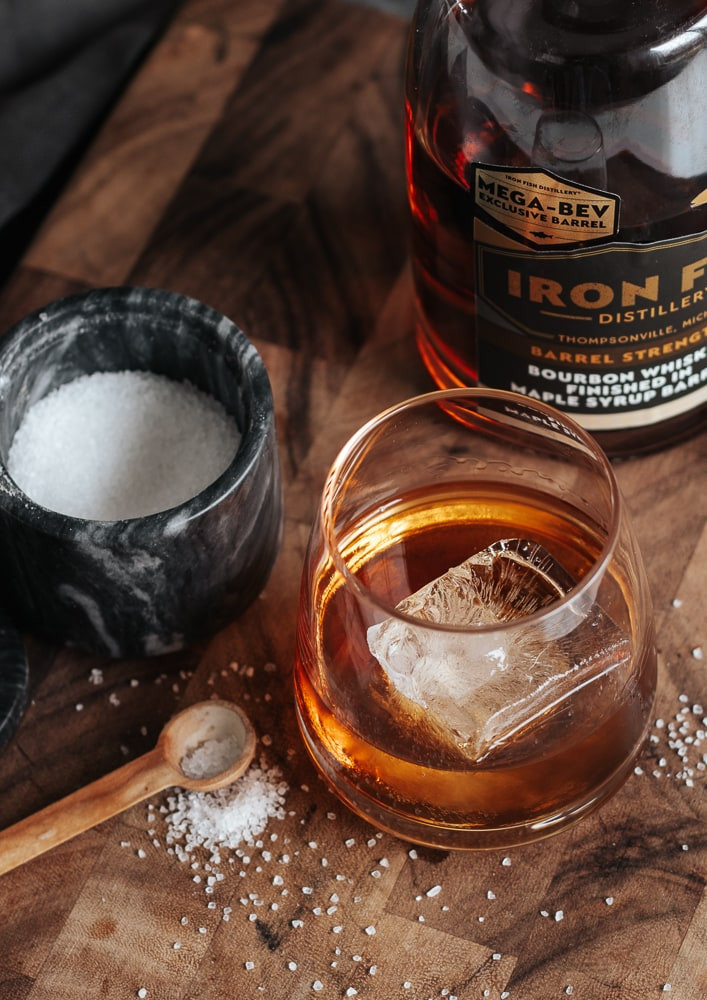 bourbon in a cocktail glass with maple syrup and salt