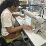 Fashion design student working on a sewing machine