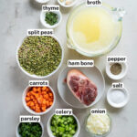 Ingredients for split pea soup including split peas, carrots, celery, onion, garlic, parsley, thyme, bay leaf, salt, pepper, ham bone, and chicken broth.