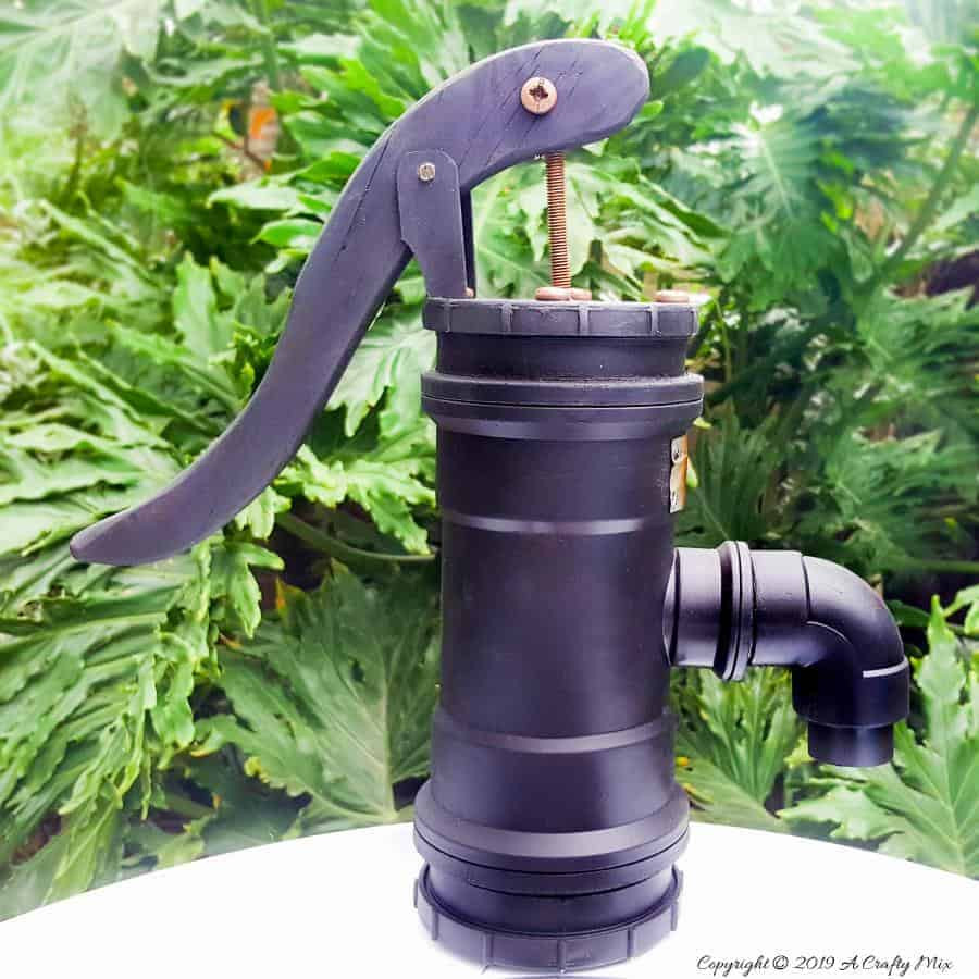How to make your own faux antique hand water pump from PVC pipes. Full DIY tutorial at A Crafty MIx #paintingPVCPipes #DIYPaintingPVC #acraftymix #DIYTutorial #fauxhandwaterpump #antiquewaterpump