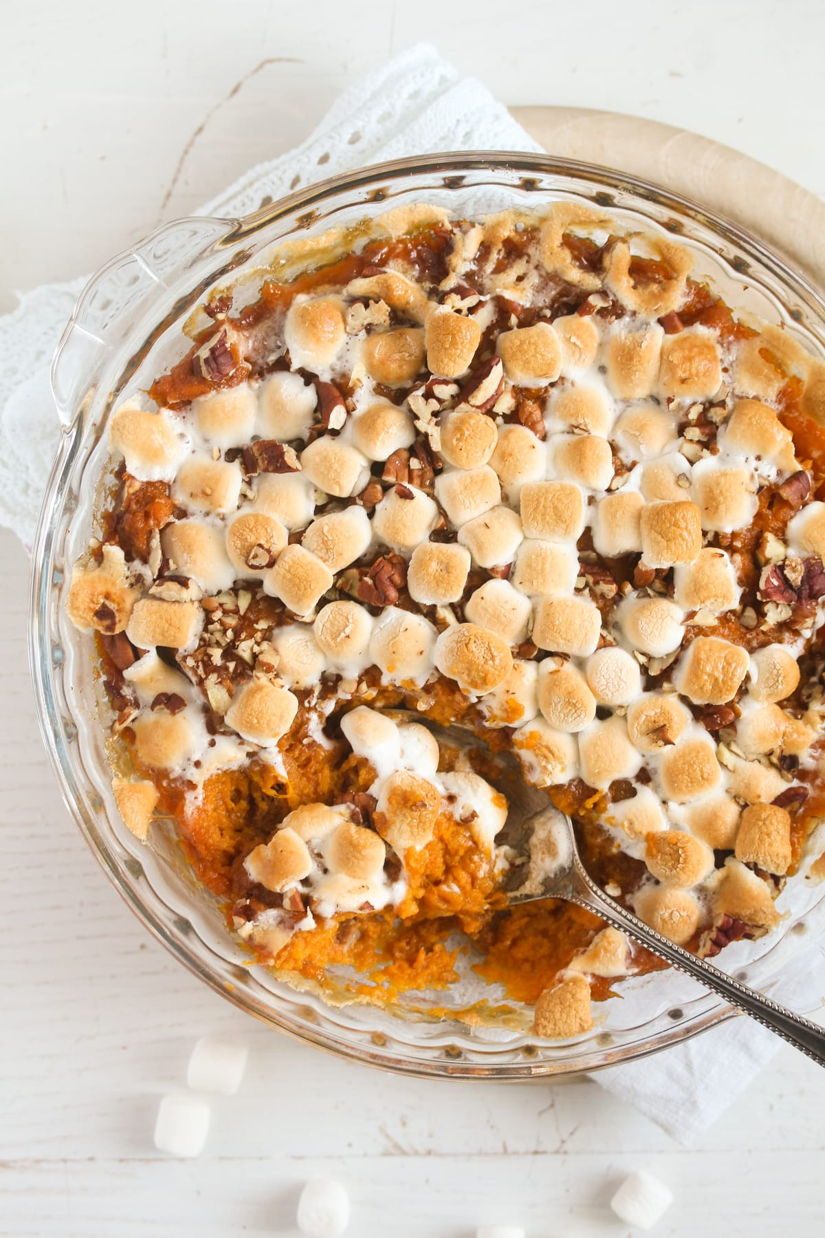 Sweet potato casserole with marshmallow topping, baked in a dish, ready to be served during Thanksgiving dinner, showcasing a blend of traditional and comforting food.