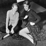 Teenagers in capri pants and circle skirt, representing popular casual 1950s fashion for women.