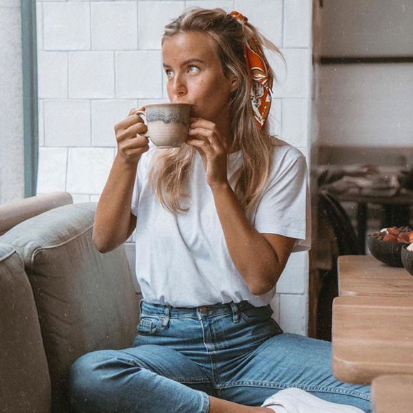Teen girl in a minimalist outfit with a white tee and jeans